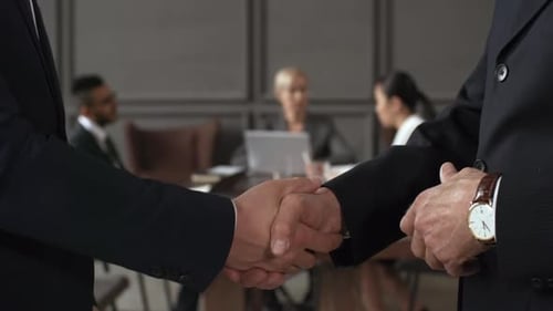 Confident Businessmen Handshake at Meeting Conclusion