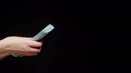 Currency Exchange Between Two Hands on Black