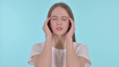 Young Adult Woman Rubbing Temples in Discomfort