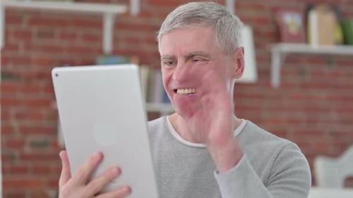 Adult Man Talking to Tablet in Home