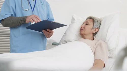 Doctor Visits Patient in Hospital Bed