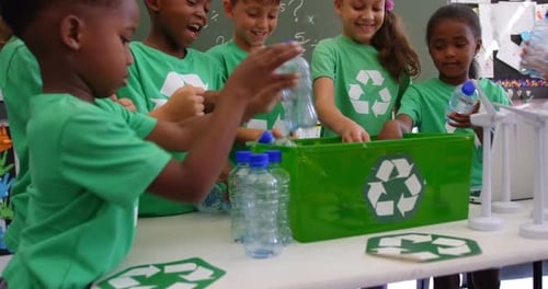 Children Recycling Plastic Bottles in Classroom