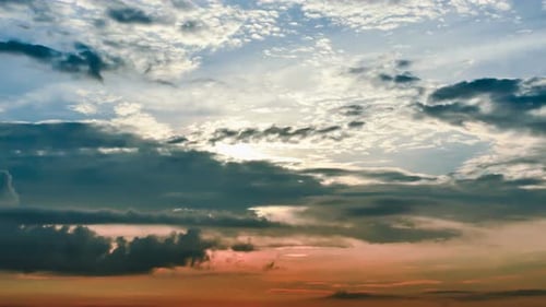 Dramatic Clouds Moving Across a Golden Sunrise Sky