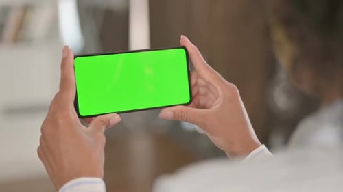 African Woman Watching Green Chroma Key Smartphone Screen