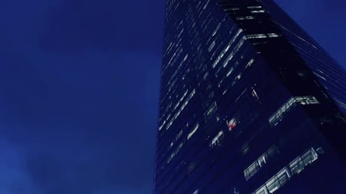 Modern Skyscraper Time-Lapse from Night to Day with Clouds