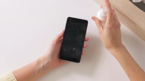 Close Up of Woman Cleaning Smartphone