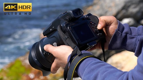 Photographer Adjusting Camera Settings