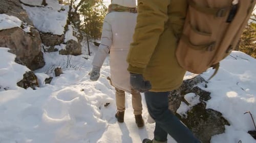 Friends Walking Down Mountain Slope