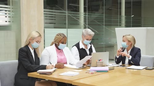 Busy Colleagues in Masks in the Office Wearing Formal Clothes During Pandemic Covid19
