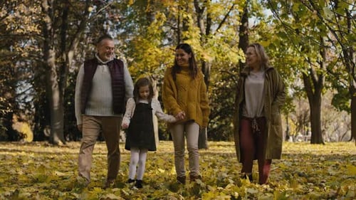 Caucasian family walking in park together. Shot with RED helium camera in 4K