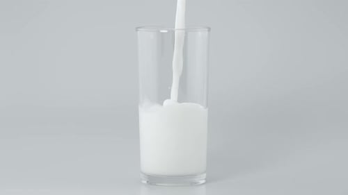 Fresh Milk Being Poured Into a Glass