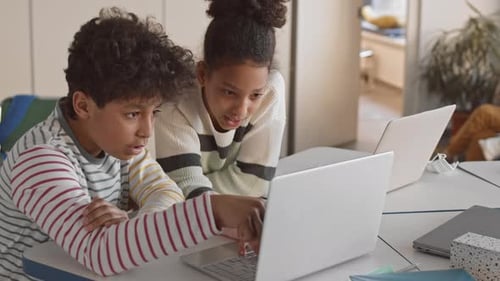 Children Studying Together Using Laptop in Classroom