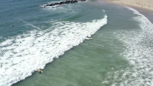 Surfer riding and turning with spray on blue ocean wave, surfing ocean. Aerial