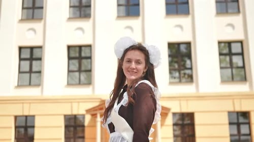 Smiling Graduate in Front of School Building