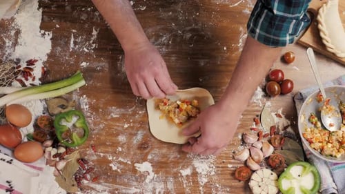 Man Cooking Empanadas Tarte Argetinian Pie Boulangerie traditionnelle d'Argentine Chef remplissant la pâte à la maison