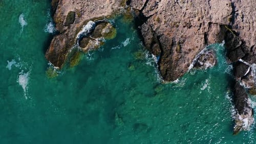 Aerial top view of Crystal Clear Water in the Mediterranean Sea. Fly over rocks in Ocean