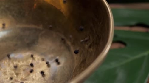 Whole and Ground Black Peppercorns on Old Wooden Table Dropped Pour in Bowl