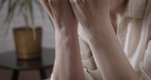 Woman with Hands on Face Suffering