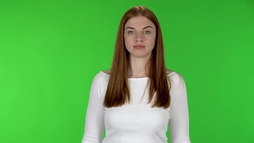 Woman Pointing at Chroma Key Background