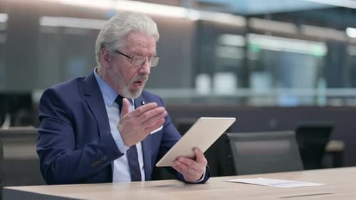Man Using Tablet With Surprised Expression