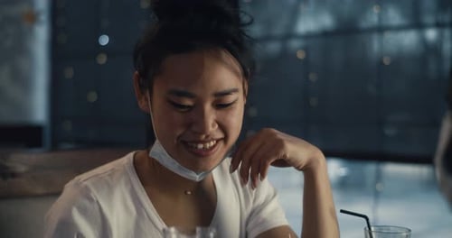 Asian Woman with Mask Speaking with Friend in Cafe