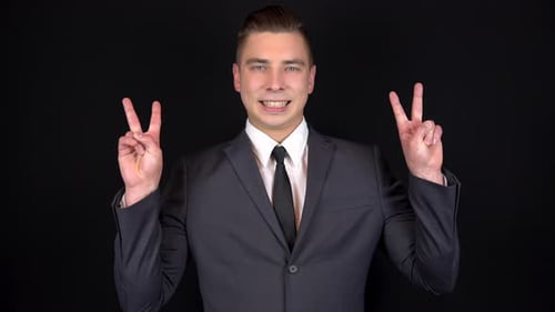 Man Makes Peace Sign in Business Suit