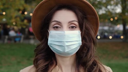 Woman Wearing Mask in Park During Daytime