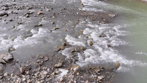 Flying Over Wild Mountain River Flowing with Stone Boulders and Rapids