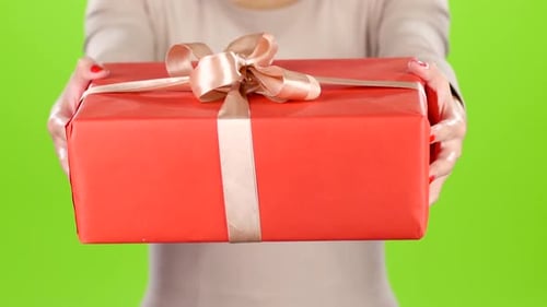 Woman Presents Red Gift on Green Screen