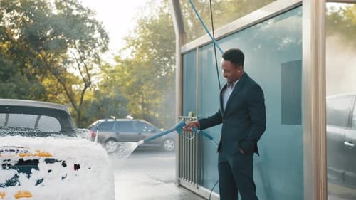 Washing of Yellow Modern Car on Open Air Self Car Wash Service with Foam and