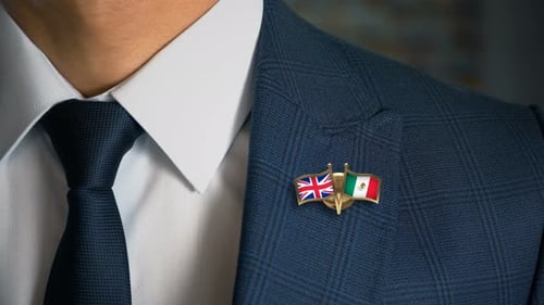 Man in Suit with UK and Mexico Flag Pin