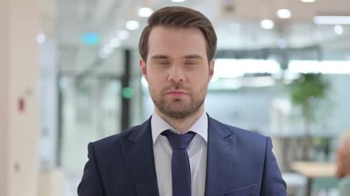 Confident Man in Suit Looking at Camera