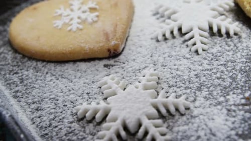 Heart shape cookies with snowflake and icing sugar on tray