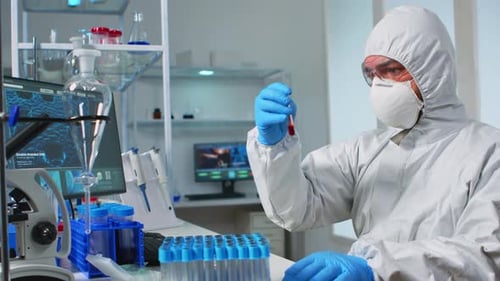 Medical Researcher Examining Test Tubes in Laboratory