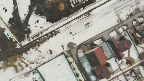 Cottage Complex Burgundy Rooftops with Snowy Yards and Roads