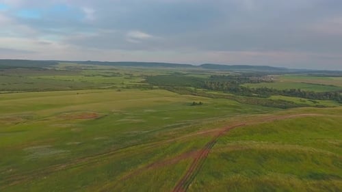 Flying Over Hills in Foothills of Urals at Sunset