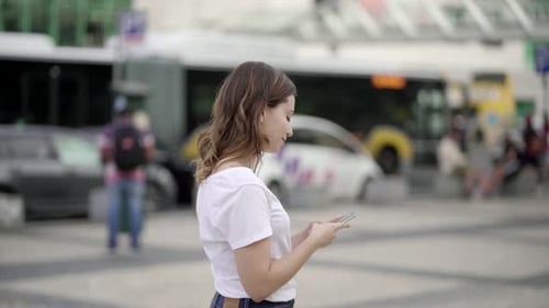 Side View of Attractive Young Lady Using Phone