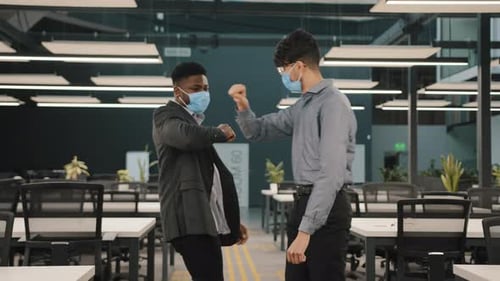 Colleagues Elbow Bump Greeting in Office During Pandemic