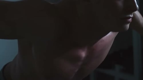 Muscular Man Working Out Indoors with Weights