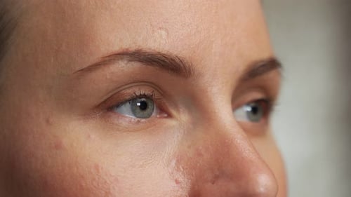 Closeup of a Beautiful Young Woman with Blue Eyes Looking Sideways