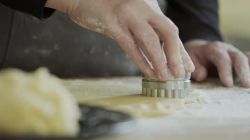 Cutting Cookie Dough with Cutter in Kitchen
