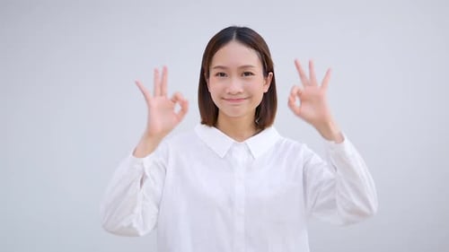 Young Woman Making Okay Hand Gesture