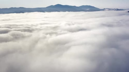 Aerial View of Mountains Above the Clouds