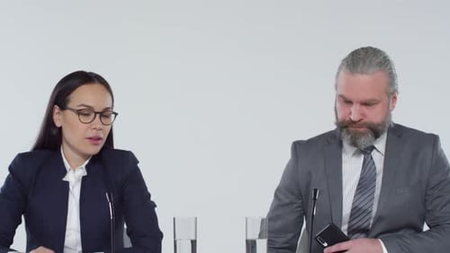 Business People Sit at Conference Table