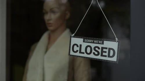 Business Closed Sign Hanging on Storefront Door