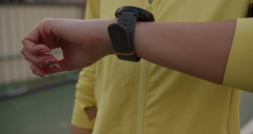 Young athlete lady exercises check progress looking heart rate monitor on smartwatch in city