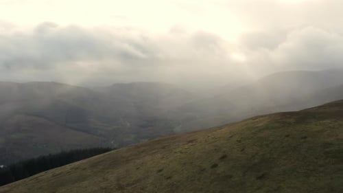 Shot of the Mountain Ranges and the Riverbank on a Cloudy Day