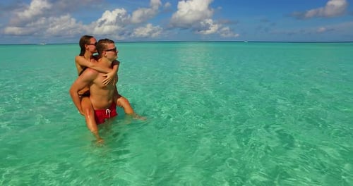 Happy boy and girl married on vacation enjoy luxury on beach on summer white sandy