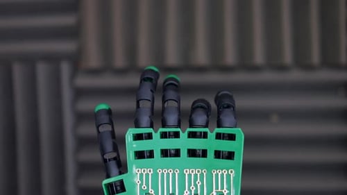 Green and Black Robotic Hand Close Up