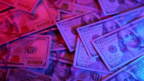 Pile of Money Illuminated by Changing Neon Lights